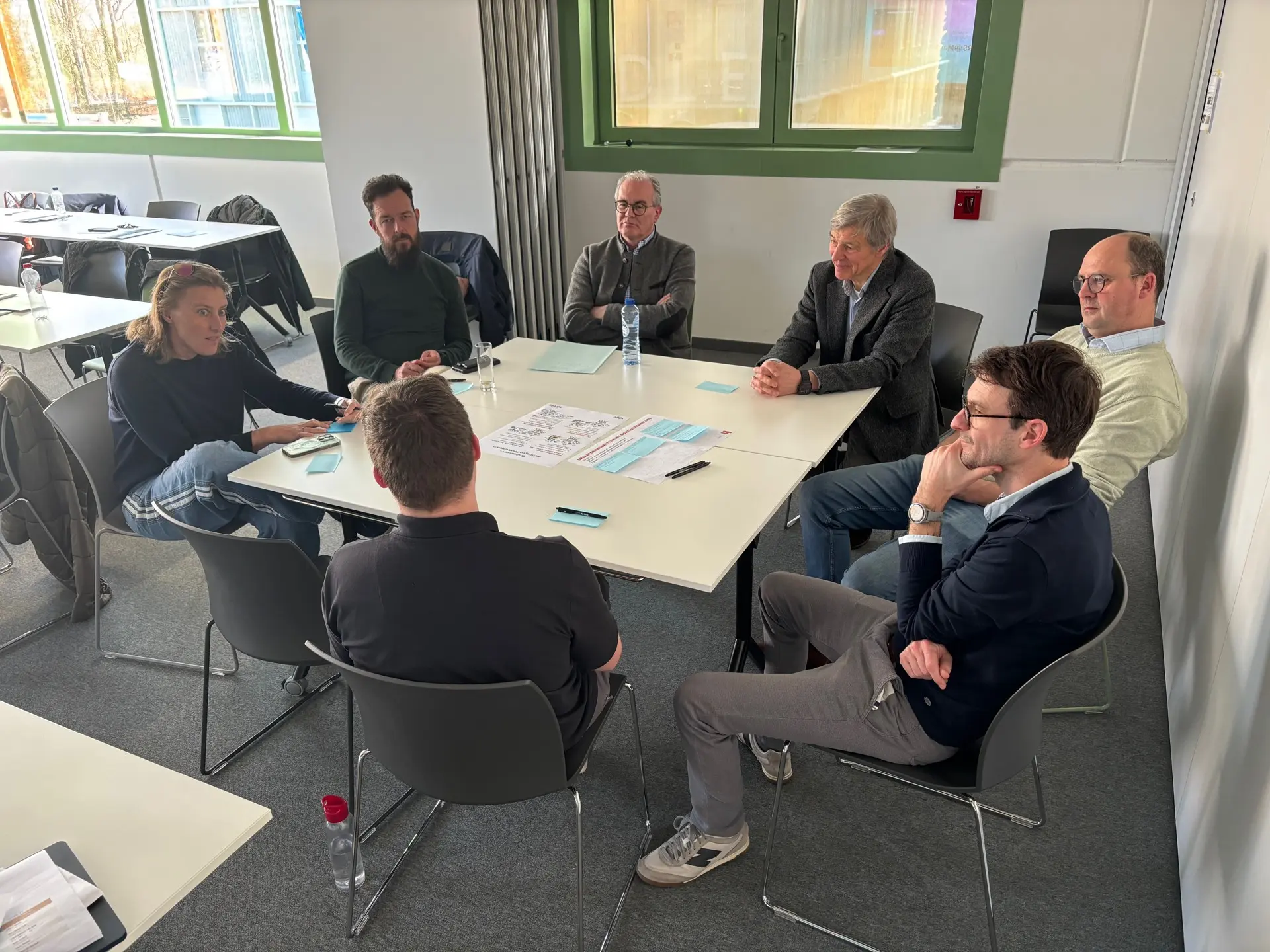 The fourth group in conversation around the table