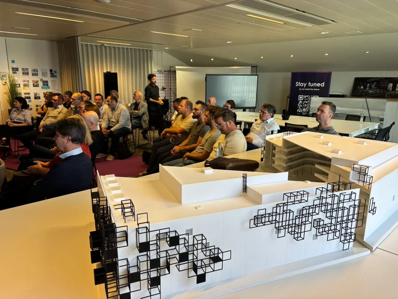 A full room at the Corda Campus with the scale model of the Arena at the front
